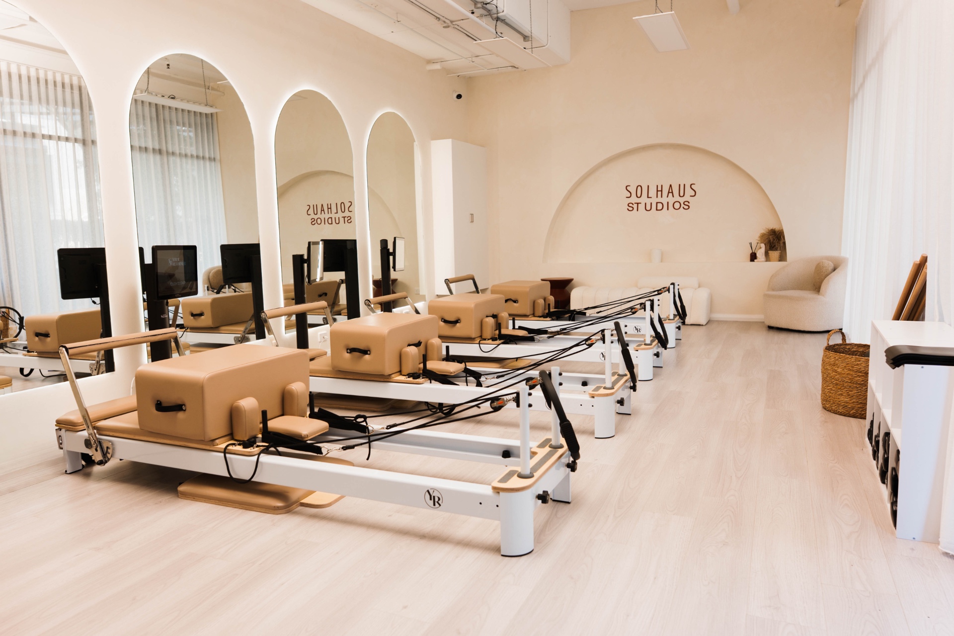 The Solhaus reformer floor with arched mirrors and warm cream walls